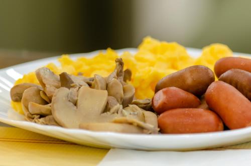 a plate of food with meat potatoes and other foods at Hotel Duas Nações in Lisbon