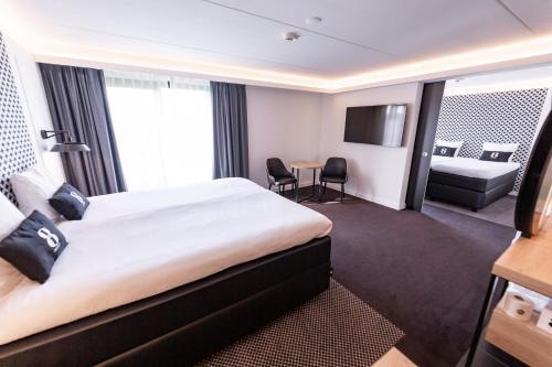 Postel nebo postele na pokoji v ubytování Gr8 Hotel Sevenum