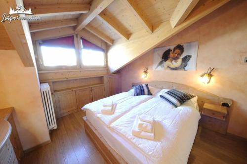 una camera da letto con un grande letto in mansarda di Chalet Lucky Exlusive Chalet a Livigno