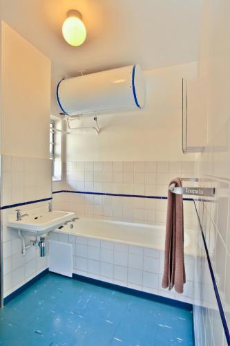a bathroom with a tub and a sink at Impala Holiday Flats & Apartments in Durban