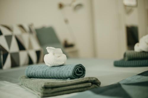 a stack of towels with a soap on top of them at Apartman Bombonica in Banja Koviljača