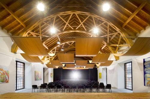 a large room with chairs and a stage at Penzion Panský dvůr Telč in Telč