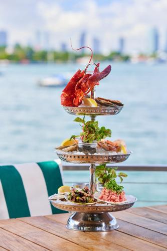 a three tiered plate of food on a table at Mondrian South Beach in Miami Beach