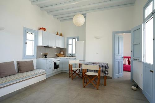 a kitchen with a table and a couch in a room at Serifos cozy home with a view in Livadakia