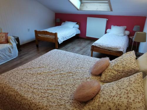 a bedroom with two beds and a window at La maison de Céline in Arry