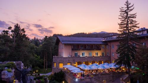 a building with a crowd of people in front of it at Spa Hotel Dvoretsa in Velingrad
