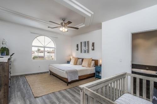 a bedroom with a bed and a ceiling fan at Luxury Estate in Prime Location w Panoramic views of Lake Havasu in Lake Havasu City