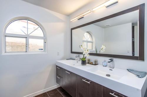 a bathroom with a sink and a large mirror at Luxury Estate in Prime Location w Panoramic views of Lake Havasu in Lake Havasu City
