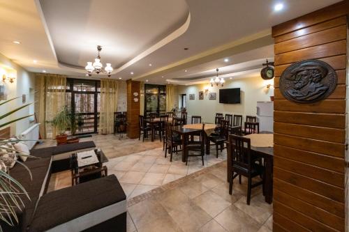a restaurant with tables and chairs in a room at Pension Master in Sinaia