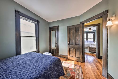 a bedroom with a blue bed and a window at Newly Renovated Home Close to Dtwn Lawrence! in Lawrence