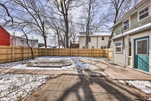 a house with a fence and a yard with snow at Newly Renovated Home Close to Dtwn Lawrence! in Lawrence
