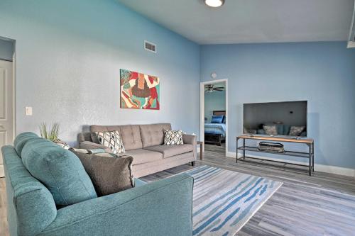 a living room with a couch and a tv at Port Richey Getaway with Lanai, Pool and Grill! in New Port Richey