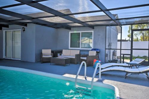 a swimming pool with a patio and a swimming pool at Port Richey Getaway with Lanai, Pool and Grill! in New Port Richey