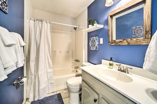 a blue bathroom with a sink and a toilet at Updated Home in the Heart of Saratoga Springs in Saratoga Springs
