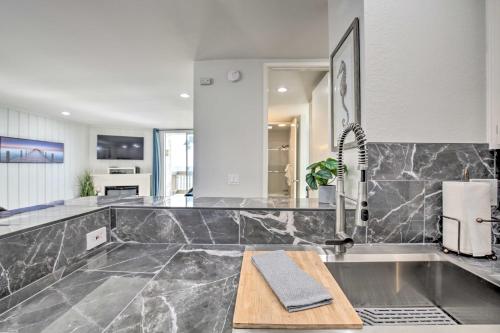a kitchen with a marble counter top and a sink at Charming Oceanside Condo with Beach and Pool Access! in Oceanside