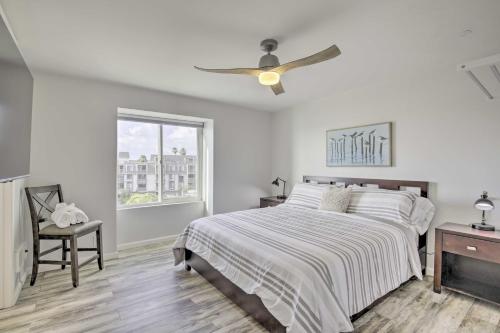 a white bedroom with a bed and a ceiling fan at Heavenly Oceanfront Condo with Amenities Galore in Oceanside