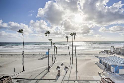 a view of a beach with palm trees and the ocean at Charming Oceanside Condo with Beach and Pool Access! in Oceanside