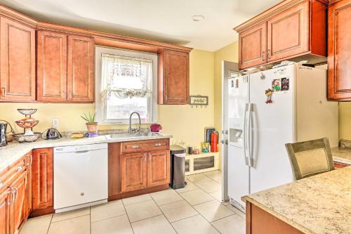 a kitchen with wooden cabinets and a white refrigerator at Long Branch Apartment 1 Mi to Beach, Pier Village in Long Branch