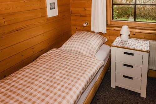 a small bedroom with a bed and a night stand at Kastanienhof in Kalleby