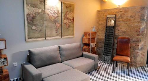 a living room with a couch and a map on the wall at Hotel Rural La Casa de Carlota in Montánchez