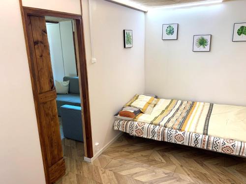 a small bedroom with a bed and a mirror at DOM LAS 3-natura, relaks, jacuzzi, akwen Jeziorsko in Kolonia Strachocice