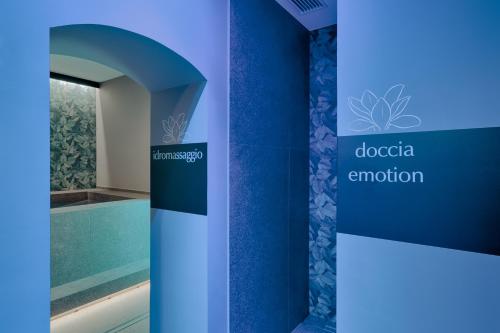 a blue wall with a sign for a pool at Hotel Villa Quiete in Montecassiano
