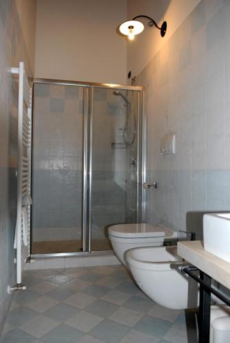 a bathroom with a shower and a toilet and a sink at Locanda dei Rii in Manerba del Garda