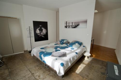 a bedroom with a bed with blue and white sheets at Duplex with a view in Montpellier