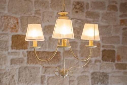 a couple of lights hanging from a wall at Grannys Villas finiki in Karpathos Town