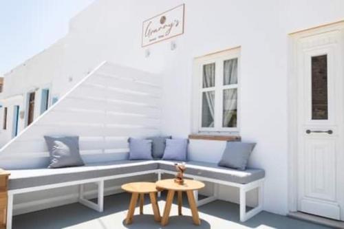 a blue bench in a room with a staircase at Grannys Villas finiki in Karpathos Town