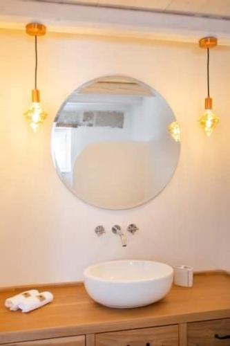 a bathroom with a white sink and a mirror at Grannys Villas finiki in Karpathos Town
