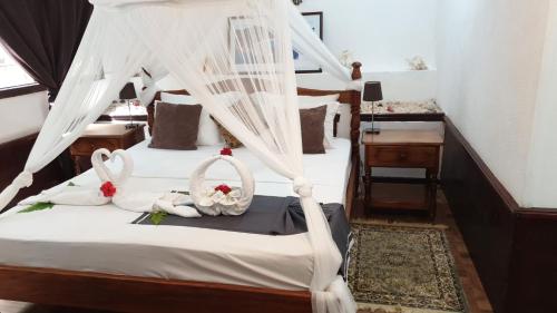 a bedroom with a bed with white mosquito nets at Belle Des Iles in La Digue