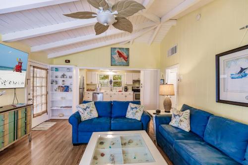 a living room with a blue couch and a ceiling fan at Siesta Key Island Rentals in Siesta Key
