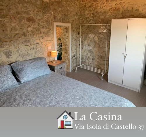 a bedroom with a bed and a white cabinet at La casina in Sonnino