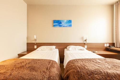 Postel nebo postele na pokoji v ubytování Tri Hotel Executive Lajeado