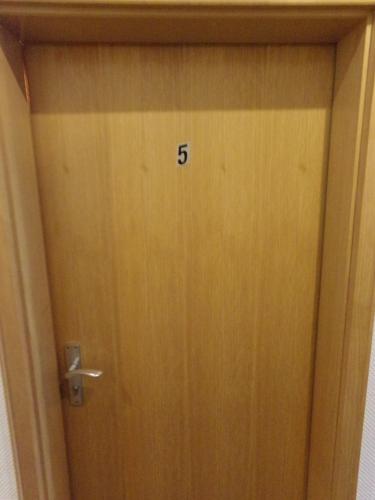 a wooden door with the number on it at Sauerland-Hotel in Essentho