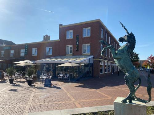 a statue of a seahorse in front of a building at Hotel Du Commerce in Oostburg