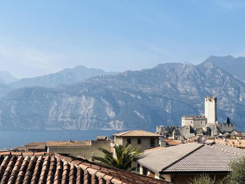 a view of a town with mountains in the background at CA' ROMEO in Malcesine