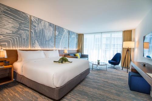 a hotel room with a large bed and a desk at B Ocean Resort Fort Lauderdale Beach in Fort Lauderdale