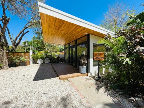 a modern house with a wooden roof at Hotel El Manglar in Playa Grande