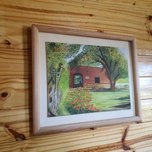 a picture of a painting hanging on a wall at Rancho Por Fin in Barreal