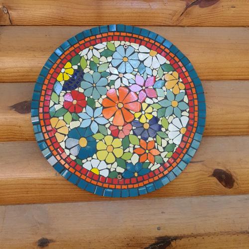 a plate with a flower pattern on a table at Rancho Por Fin in Barreal