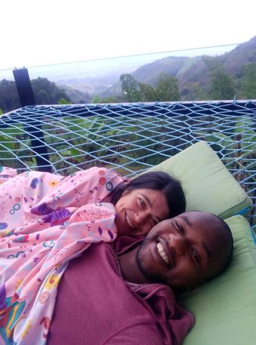 a man and a woman laying on a bed at Cristal House Glamping at Villa Migelita Ecolodge in Palmira