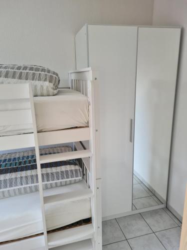 a bedroom with bunk beds and a mirror at Watt will man Meer in Cuxhaven