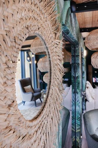 a mirror on a wall with a chair in a room at Harda House Friends & Spa in Zakopane