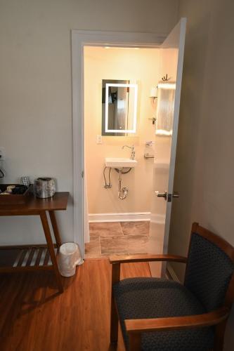 a bathroom with a sink and a mirror at The Lakehouse Inn Geneva in Geneva-on-the-Lake