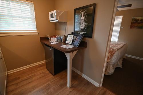 a small desk in a room with a bed at The Lakehouse Inn Geneva in Geneva-on-the-Lake