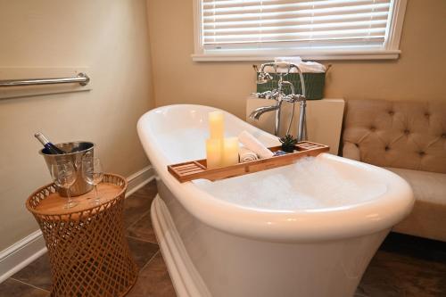 a bathroom with a bath tub with candles on it at The Lakehouse Inn Geneva in Geneva-on-the-Lake