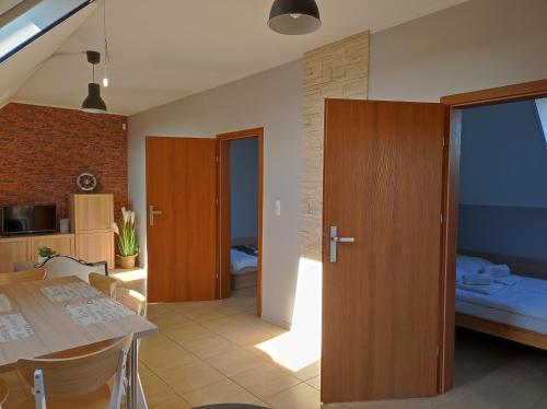 a room with a kitchen and a dining room at Morskie Opowieści in Mikoszewo