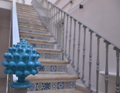 a staircase with a blue vase in front of it at The Court Suites & Spa in Taranto